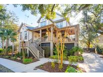 Two-story home with front porch and landscaped yard at 1123 Oak Overhang St, Charleston, SC 29492