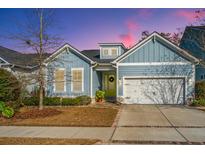 Charming craftsman style home with light blue siding, a yellow door, and a brick-paved walkway at 1258 Gannett Rd, Mount Pleasant, SC 29464