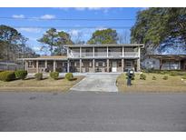 Two-story house with a large front porch and driveway at 1520 Acacia St, Charleston, SC 29407