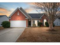 Brick ranch home with attached garage and landscaping at 1633 Pin Oak Cut, Mount Pleasant, SC 29466