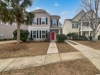 Two-story house with red door, gray siding, and landscaping at 1813 Towne St, Johns Island, SC 29455