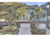 Tan and blue two-story townhome with double garage and landscaping at 9185 Parlor Dr, Ladson, SC 29456
