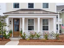 Two-story home with a charming front porch and metal roof at 1245 Crooked Oak Rd, Charleston, SC 29492