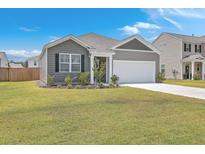 Gray siding house with white garage door, landscaping, and fenced yard at 133 Summit View Dr, Summerville, SC 29486