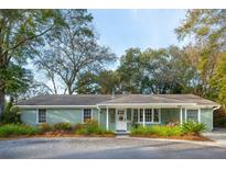 Charming ranch home with a light green brick exterior and covered porch at 1446 Fort Johnson Rd, Charleston, SC 29412