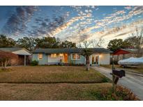 Charming house with a landscaped yard and a covered carport at 1569 Westwood Dr, Charleston, SC 29412