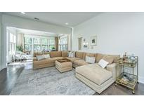 Spacious living room with large sectional sofa and sunroom access at 2910 Clearwater Dr, Mount Pleasant, SC 29466