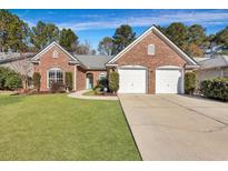 Brick ranch home with two-car garage and landscaped lawn at 3246 John Bartram Pl, Mount Pleasant, SC 29466