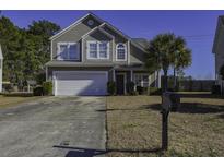 Two-story house with attached garage and manicured lawn at 547 Pleasant Side Dr, Moncks Corner, SC 29461