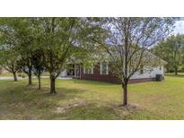 Brick ranch house with attached garage and landscaped yard at 669 Heyward Ln, Moncks Corner, SC 29461