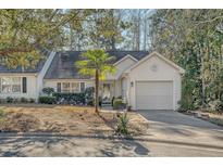 White house with palm tree and driveway at 9117 Woodcreek Ct, North Charleston, SC 29406