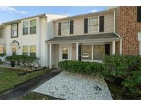Two-story townhome with a covered porch and well-maintained landscaping at 1101 Reserve Way, Summerville, SC 29485
