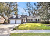 Brick ranch house with 2-car garage, mature landscaping, and a spacious lawn at 114 Boone Dr, Summerville, SC 29485