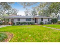 Ranch style home with gray brick and well-manicured lawn at 1159 Wyndham Rd, Charleston, SC 29412