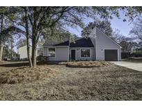 Newly renovated gray house with a landscaped yard and driveway at 117 Hummingbird Ave, Ladson, SC 29456