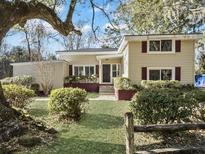 Ranch style home with a landscaped lawn and a wooden fence at 138 Green Pond Hwy, Walterboro, SC 29488