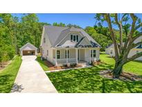 Craftsman style home with front porch, detached garage, and mature landscaping at 2841 Auldreeke Rd, Johns Island, SC 29455
