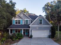 Two-story gray house with blue shutters, a large yard, and a two-car garage at 469 Fort Johnson Rd, Charleston, SC 29412