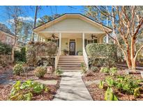 Charming light-green house with a wrap-around porch and well-manicured landscaping at 5135 Coral Reef Dr, Johns Island, SC 29455