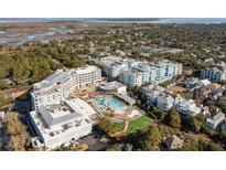 Aerial view of a resort community with pools, lush landscaping, and various buildings at 5804 Palmetto Dr # A-201/203, Isle of Palms, SC 29451