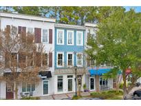 Three-story building with blue and white siding, multiple storefronts, and ample parking at 712 S Shelmore Blvd # 15, Mount Pleasant, SC 29464