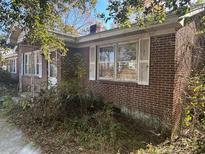 Brick ranch house with white shutters, needing some landscaping at 1413 Sumner Ave, North Charleston, SC 29406