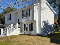Two-story house with white siding, brick accents, and a landscaped yard at 228 Mohican Cir, Summerville, SC 29483