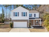 Two-story house with brick and siding, gray shutters, and a two-car garage at 2700 Sunrose Ln, Johns Island, SC 29455