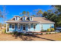 Charming light blue house with a front porch and landscaped yard at 273 Plantation Ln, Walterboro, SC 29488