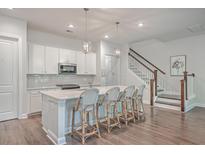 Modern kitchen with white cabinets, quartz countertops, and stainless steel appliances at 3012 Emma Ln, Mount Pleasant, SC 29466