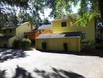 Yellow-painted two-story building with attached garages and a wooden deck at 345 Sea Cloud Cir # 345, Edisto Island, SC 29438
