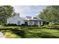 Charming farmhouse exterior with metal roof and landscaped lawn at 421 Sandridge Acres Trail, Holly Hill, SC 29059