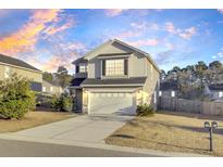 Two-story house with attached garage and landscaped yard at 9676 Godwin St, Ladson, SC 29456