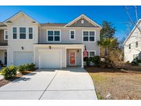 Two-story townhome with gray siding, red door, and attached garage at 9761 Transplanter Cir, Ladson, SC 29456
