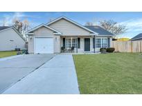 Tan house with a white garage door and black shutters at 124 Pointer Dr, Goose Creek, SC 29445