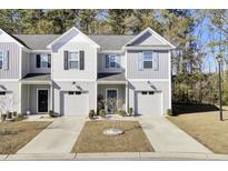 Two-story townhome with gray siding, attached garage, and landscaping at 128 Buchanan Cir, Goose Creek, SC 29445