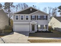 Two-story house with gray siding, dark brown accents, and a two-car garage at 145 Clydesdale Cir, Summerville, SC 29486