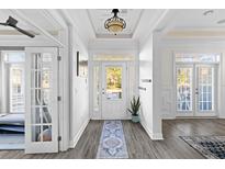 Bright and airy entryway with hardwood floors, french doors, and a view to the backyard at 1493 Nautical Chart Dr, Charleston, SC 29414