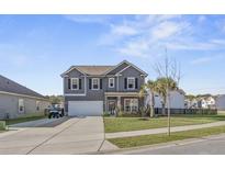 Two-story gray house with a large driveway and landscaped yard at 2122 Leopold St, Johns Island, SC 29455