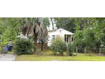 Cozy one-story house with a front porch, needing some TLC, surrounded by lush greenery at 3993 Gary Dr, North Charleston, SC 29405