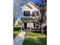 Two-story house with a brick and siding exterior, front porch, and landscaped yard at 406 Chinquapin Dr, Summerville, SC 29485