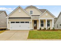 Craftsman style home with beige siding, white garage door, and manicured lawn at 519 Eagleview Dr, Moncks Corner, SC 29461