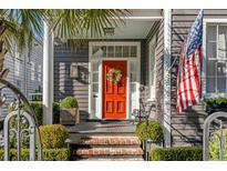 Inviting front door with a wreath and brick steps at 70 Warren St, Charleston, SC 29403