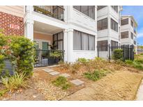 Luxury condo building with private patio and well-manicured landscaping at 1025 Riverland Woods Pl # 208, Charleston, SC 29412