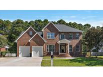 Brick home with two-car garage and landscaped lawn at 2212 Salt Wind Way, Mount Pleasant, SC 29466