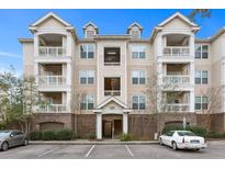 Three-story building with brick and beige siding, balconies, and ample parking at 2244 Ashley Crossing Dr # 1224, Charleston, SC 29414
