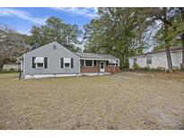 Ranch style home with gray siding, brick accents, and a spacious yard at 2736 Bonds Ave, North Charleston, SC 29405