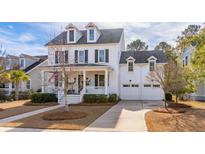 Two-story white house with black shutters, front porch, and two-car garage at 3813 Fifle St, Mount Pleasant, SC 29466