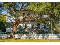 Two-story home with a white fence and mature tree in front at 416 Bank St, Mount Pleasant, SC 29464