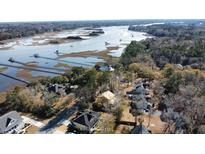 Aerial view of waterfront property with houses and expansive marsh views at 5655 Captain Kidd Rd, Hollywood, SC 29449